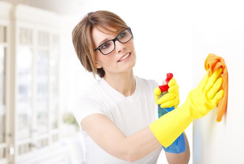 Upholstery cleaning technician treating stains on a living room sofa