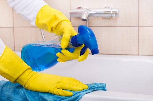 Cleaner removing grease from an oven door in Surrey